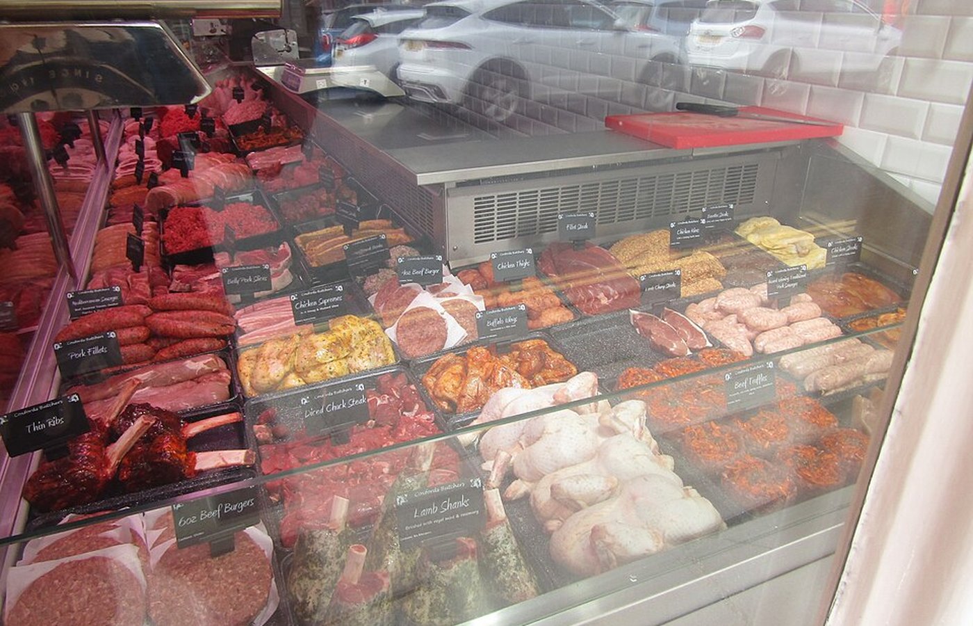 Selection of fresh raw pork cuts on a slate board